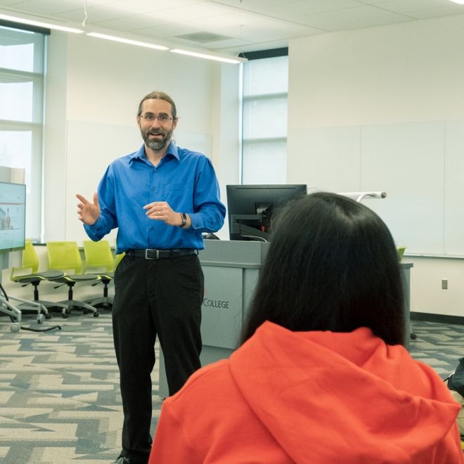 Male professor with students.